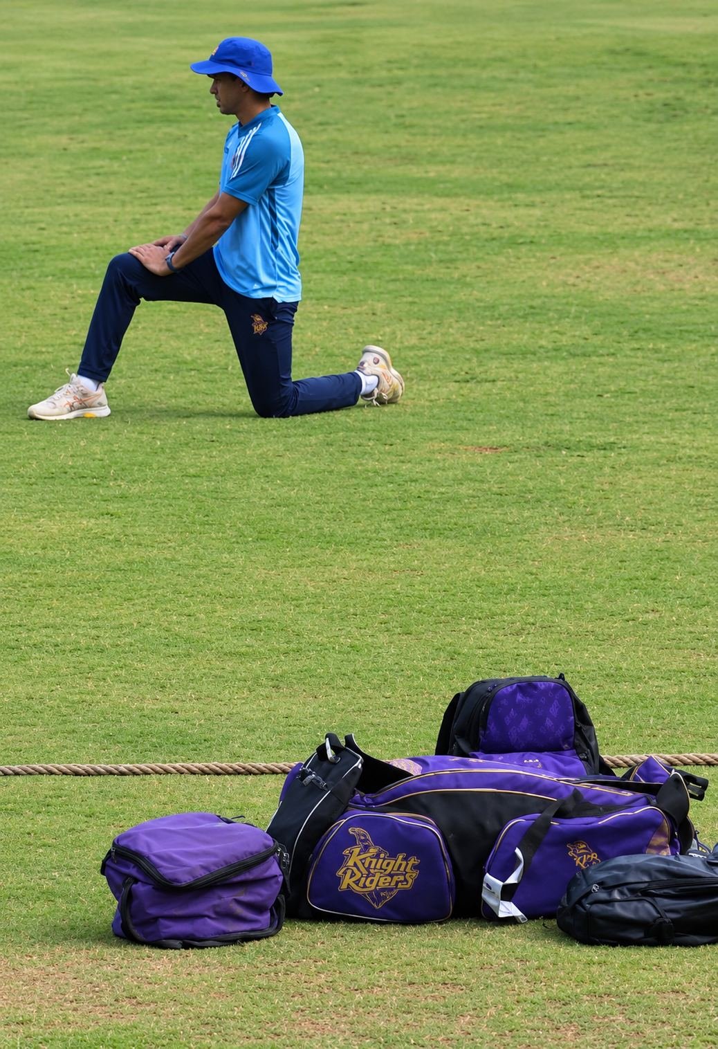 A player warming up beside Kolkata Knight Riders team kit during a talent-scouting activity at KSM
